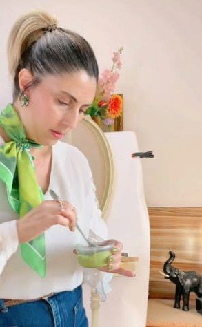 Loubna Hakim painting a cabinet